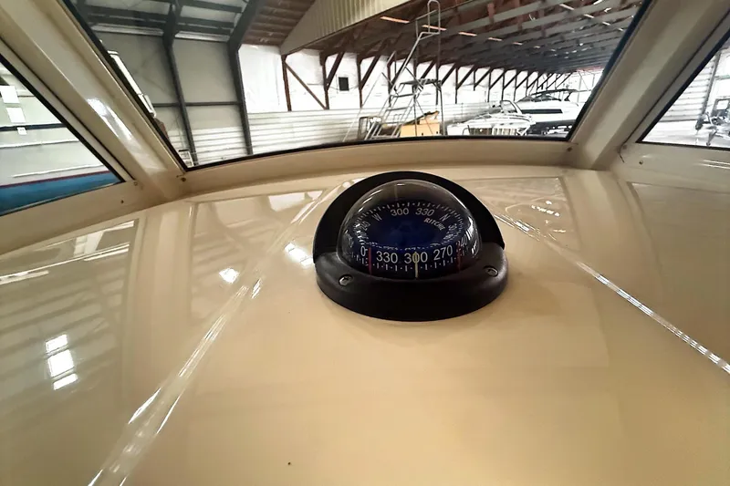  Yacht Photos Pics Compass on 2016 Scout 350 LXF boat dashboard in a marina setting.