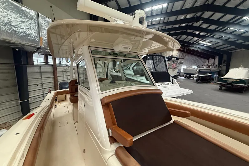 Yacht Photos Pics 2016 Scout 350 LXF boat in indoor storage, showcasing sleek design and luxury seating.
