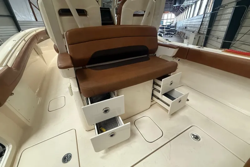 Yacht Photos Pics 2016 Scout 350 LXF boat interior with brown seating and open storage drawers.
