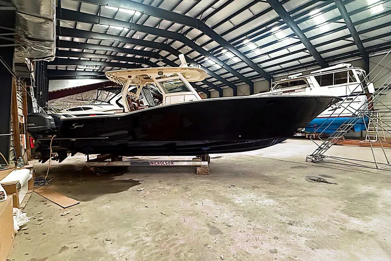  Yacht Photos Pics 2016 Scout 350 LXF boat in a spacious indoor storage facility.