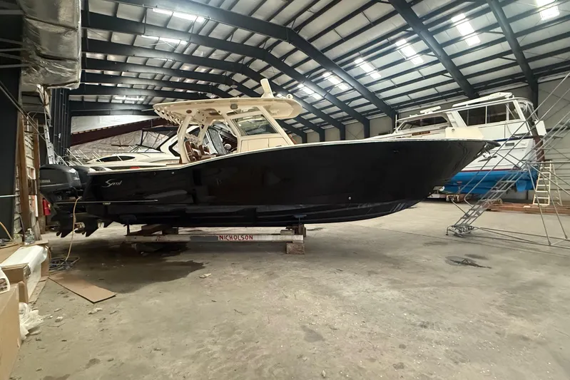  Yacht Photos Pics 2016 Scout 350 LXF boat in a spacious indoor storage facility.