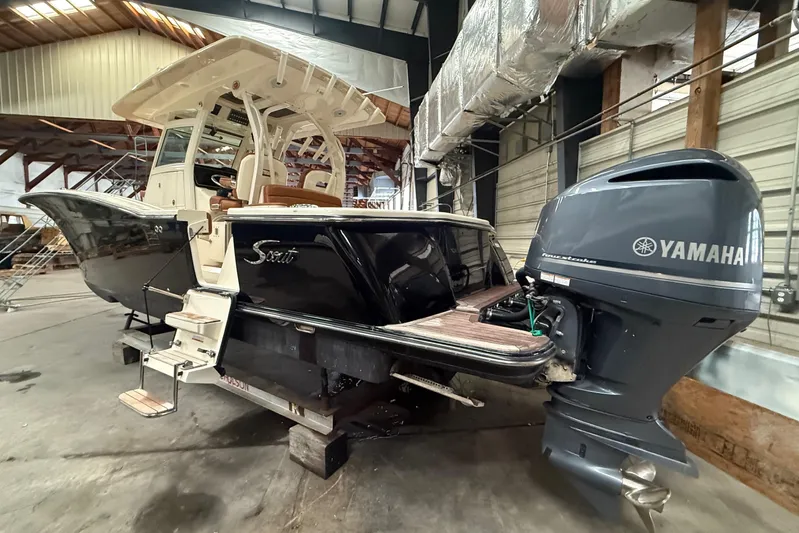 Yacht Photos Pics 2016 Scout 350 LXF boat with Yamaha outboard engine in a warehouse setting.