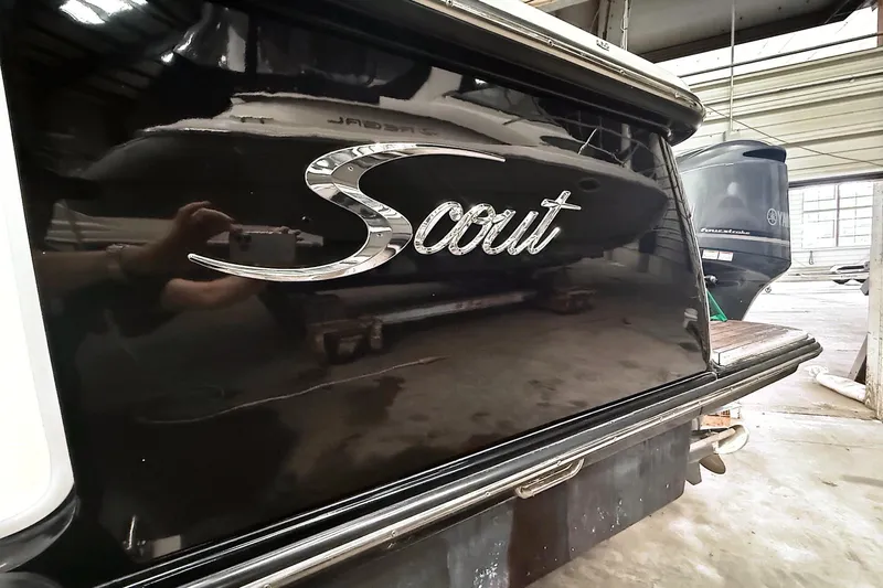  Yacht Photos Pics 2016 Scout 350 LXF boat with reflective black finish in a storage facility.