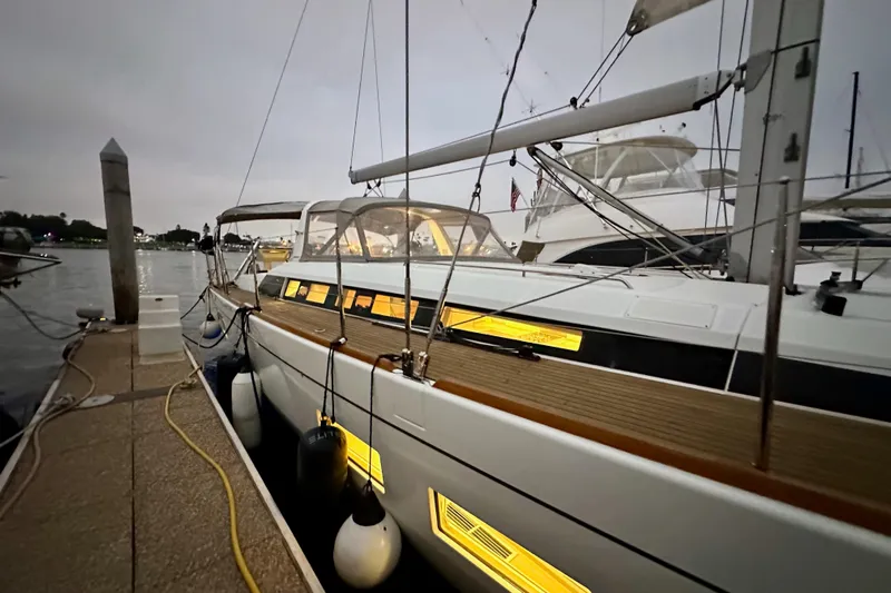 Champagne Yacht Photos Pics 2021 Beneteau Oceanis 55.1 yacht docked at marina during evening.