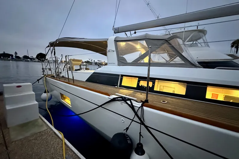 Champagne Yacht Photos Pics 2021 Beneteau Oceanis 55.1 yacht docked at marina during evening.