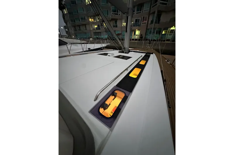 Champagne Yacht Photos Pics Beneteau Oceanis 55.1 yacht deck at night, illuminated windows, 2021 model.