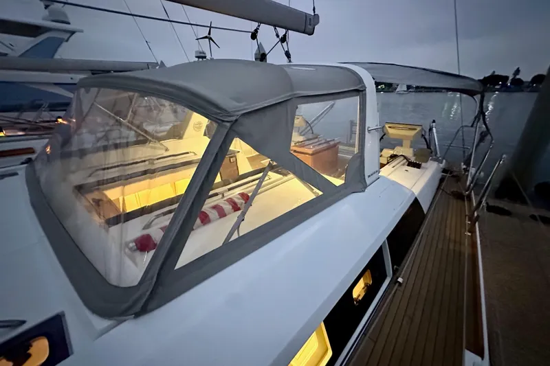 Champagne Yacht Photos Pics Beneteau Oceanis 55.1 yacht, 2021 model, docked at dusk with illuminated interior.