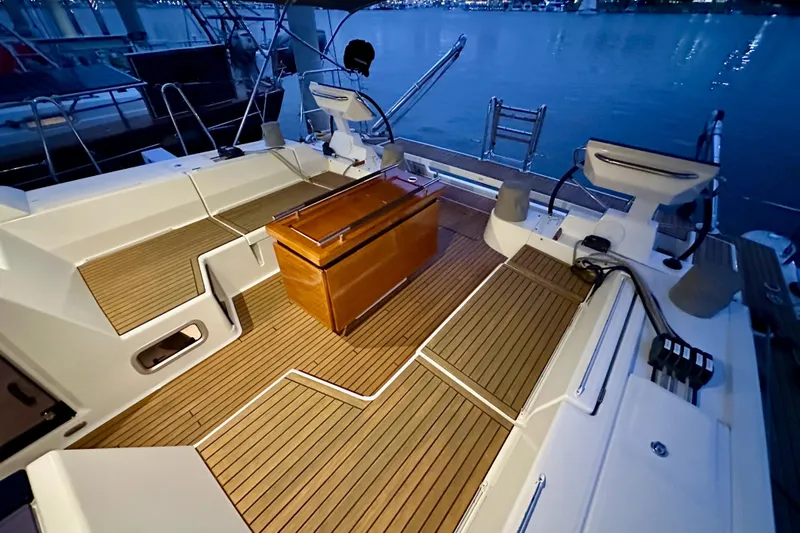 Champagne Yacht Photos Pics Luxurious 2021 Beneteau Oceanis 55.1 yacht deck with elegant wood finish at dusk.