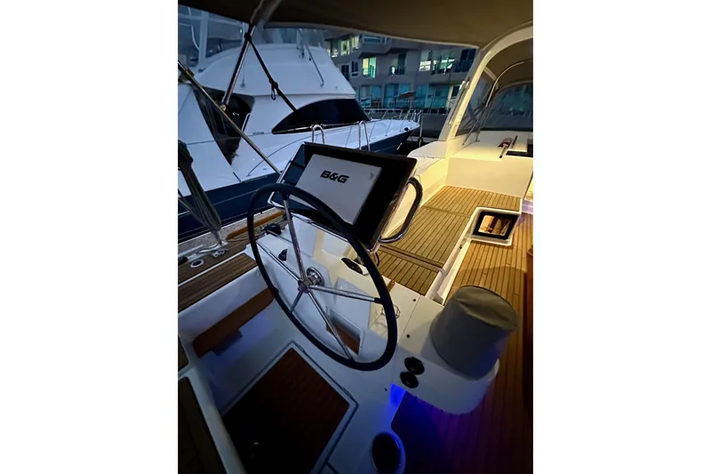 Champagne Yacht Photos Pics Cockpit of 2021 Beneteau Oceanis 55.1 yacht with steering wheel and navigation system.