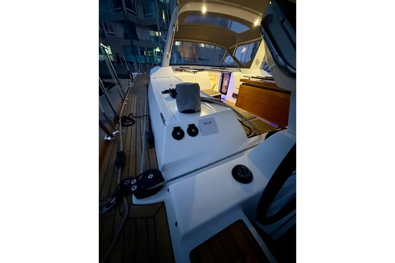 Champagne Yacht Photos Pics 2021 Beneteau Oceanis 55.1 yacht deck at night, illuminated interior, modern design.