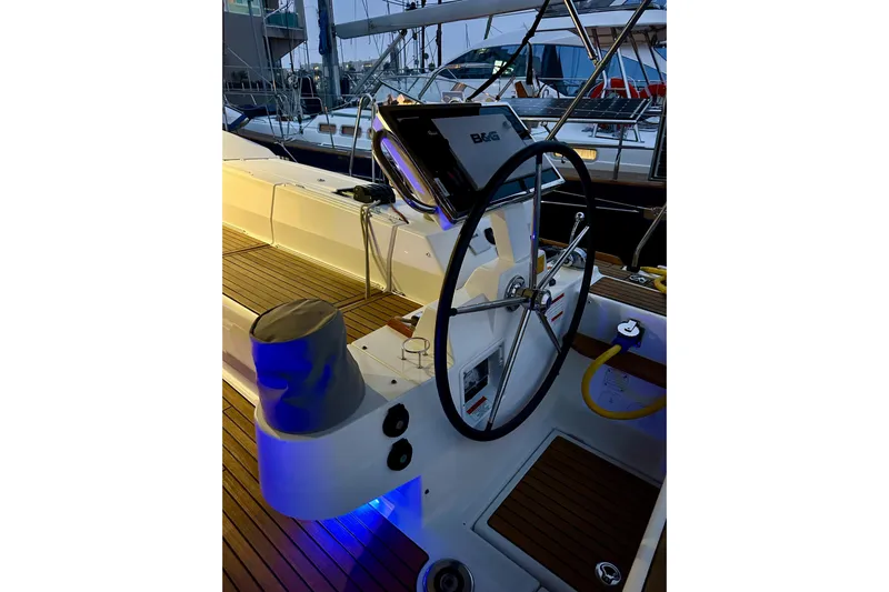 Champagne Yacht Photos Pics Steering wheel of 2021 Beneteau Oceanis 55.1 yacht with illuminated deck.