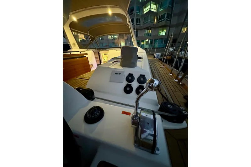 Champagne Yacht Photos Pics Cockpit view of 2021 Beneteau Oceanis 55.1 yacht at dusk, showcasing controls and deck.