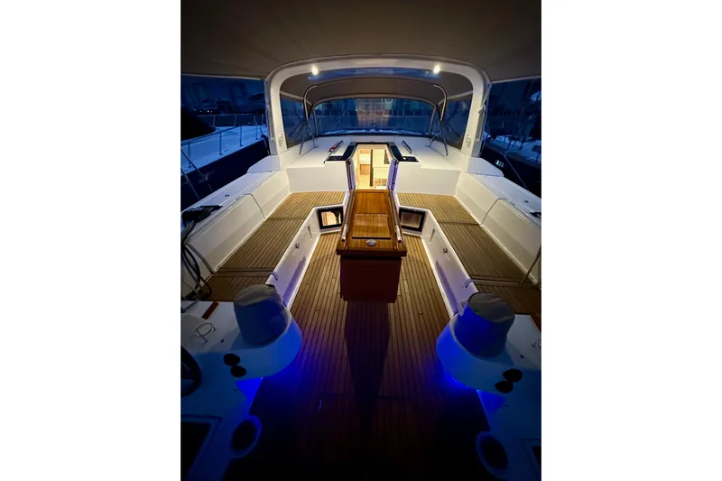 Champagne Yacht Photos Pics 2021 Beneteau Oceanis 55.1 yacht interior with elegant wood and ambient lighting.