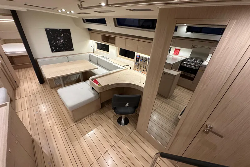 Champagne Yacht Photos Pics Luxurious interior of 2021 Beneteau Oceanis 55.1 yacht with modern kitchen and seating area.