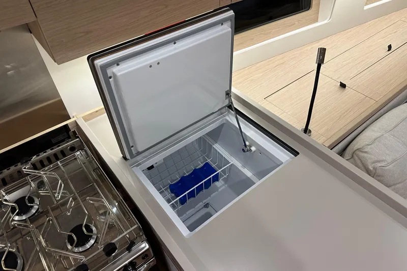 Champagne Yacht Photos Pics Open freezer in 2021 Beneteau Oceanis 55.1 yacht kitchen interior.