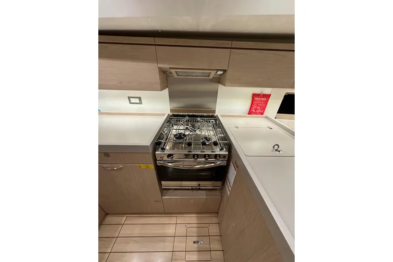 Champagne Yacht Photos Pics Modern kitchen in 2021 Beneteau Oceanis 55.1 yacht with stove and sleek cabinetry.