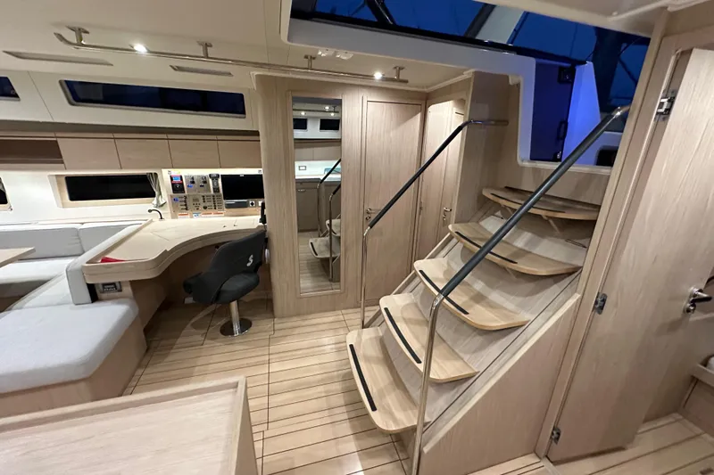 Champagne Yacht Photos Pics Luxurious interior of 2021 Beneteau Oceanis 55.1 yacht with modern design and wooden finishes.