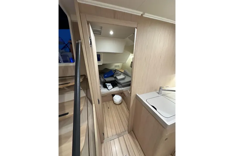 Champagne Yacht Photos Pics Interior of 2021 Beneteau Oceanis 55.1 yacht, featuring modern wood finish and compact design.