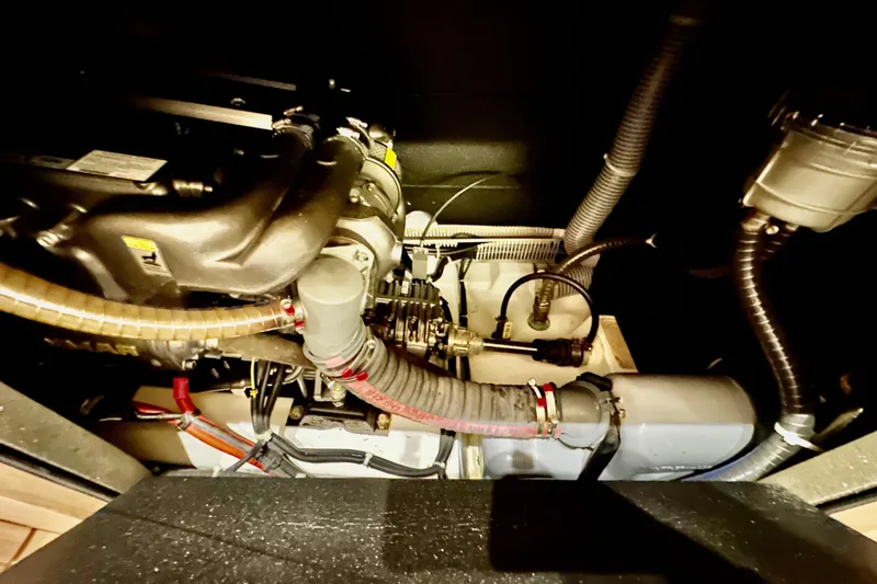 Champagne Yacht Photos Pics Engine compartment of a 2021 Beneteau Oceanis 55.1 sailboat, showcasing mechanical components.