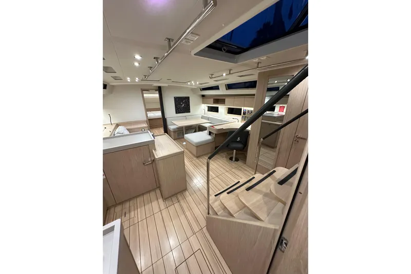 Champagne Yacht Photos Pics Luxurious interior of 2021 Beneteau Oceanis 55.1 yacht with modern design and wood finish.