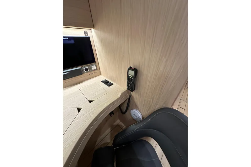 Champagne Yacht Photos Pics Interior of 2021 Beneteau Oceanis 55.1 yacht with navigation equipment and seating.