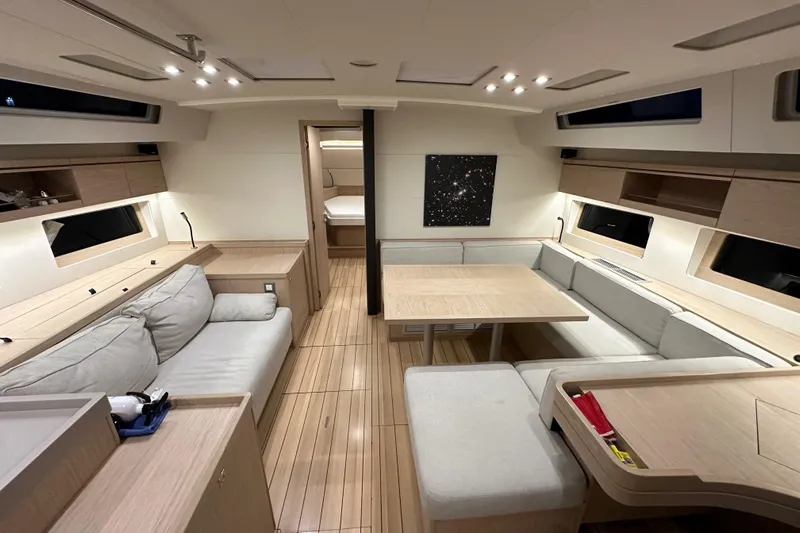 Champagne Yacht Photos Pics Luxurious interior of 2021 Beneteau Oceanis 55.1 yacht with modern seating and elegant design.
