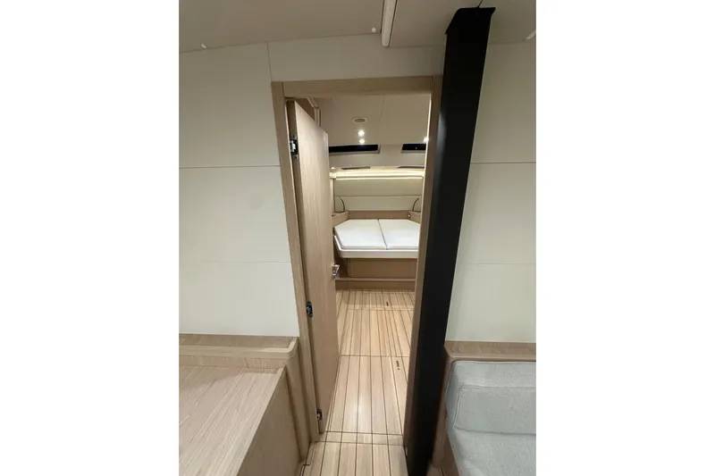 Champagne Yacht Photos Pics Interior of 2021 Beneteau Oceanis 55.1 yacht, featuring modern wood finish and cozy cabin.