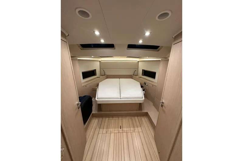 Champagne Yacht Photos Pics Luxurious interior cabin of 2021 Beneteau Oceanis 55.1 yacht, featuring modern design and wood finish.
