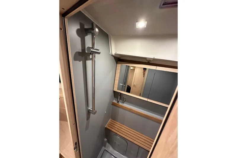Champagne Yacht Photos Pics Beneteau Oceanis 55.1 2021 yacht bathroom with modern shower and wooden accents.