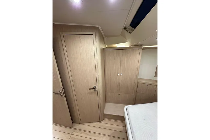 Champagne Yacht Photos Pics Interior of 2021 Beneteau Oceanis 55.1 yacht, featuring wooden cabinetry and modern design.