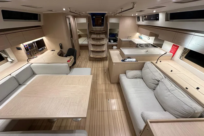 Champagne Yacht Photos Pics Luxurious interior of 2021 Beneteau Oceanis 55.1 yacht with modern furnishings and spacious layout.