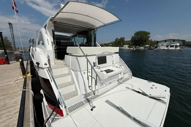  Yacht Photos Pics 2022 Cruisers Yachts 50 Cantius docked at marina, showcasing spacious deck and modern design.