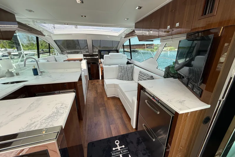  Yacht Photos Pics Luxurious interior of 2022 Cruisers Yachts 50 Cantius with modern kitchen and seating area.