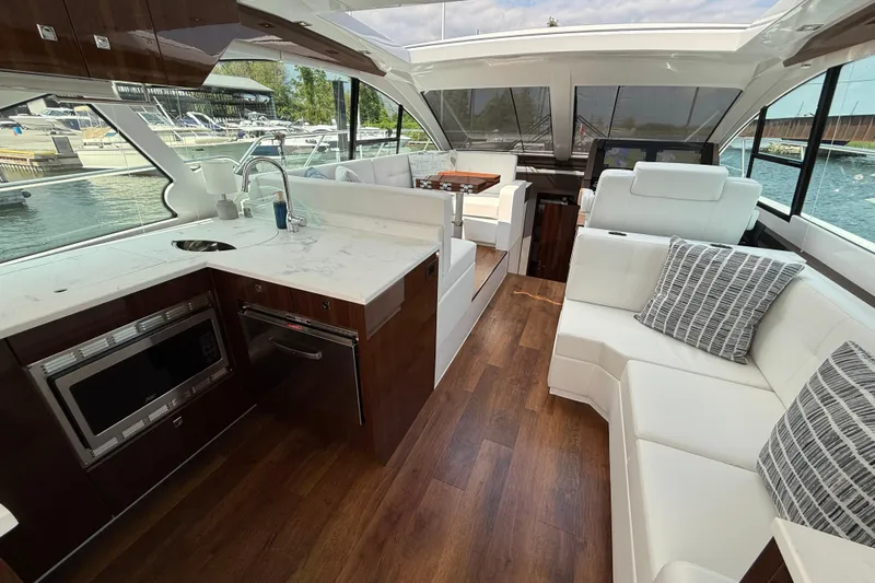  Yacht Photos Pics Luxurious interior of 2022 Cruisers Yachts 50 Cantius with modern kitchen and seating area.
