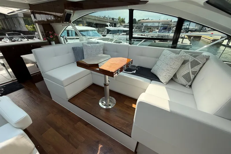  Yacht Photos Pics Luxurious interior of 2022 Cruisers Yachts 50 Cantius with elegant seating and wooden table.