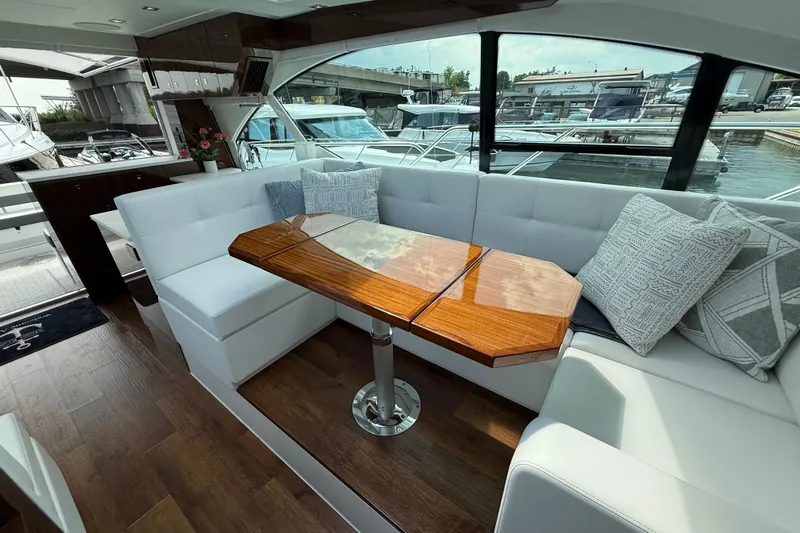  Yacht Photos Pics Luxurious interior of 2022 Cruisers Yachts 50 Cantius with elegant seating and wooden table.