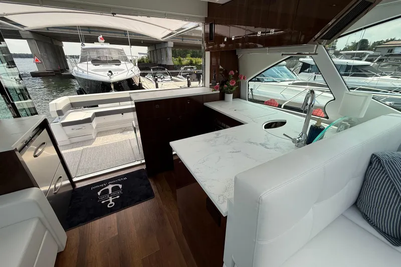  Yacht Photos Pics Luxurious interior of 2022 Cruisers Yachts 50 Cantius with modern kitchen and seating area.