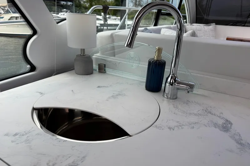  Yacht Photos Pics Luxurious 2022 Cruisers Yachts 50 Cantius kitchen sink with modern faucet and elegant countertop.