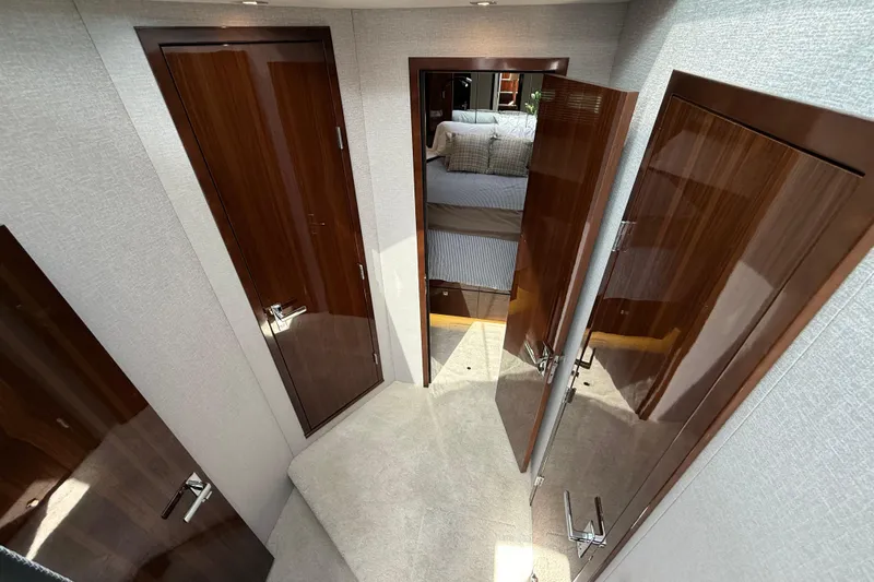  Yacht Photos Pics Luxurious interior of 2022 Cruisers Yachts 50 Cantius with polished wood doors and plush carpeting.