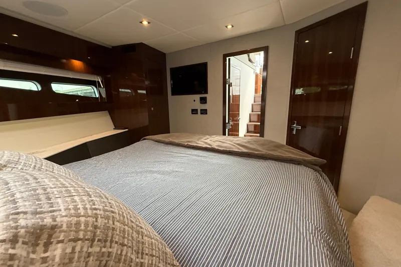  Yacht Photos Pics Luxurious bedroom interior of 2022 Cruisers Yachts 50 Cantius with modern amenities.