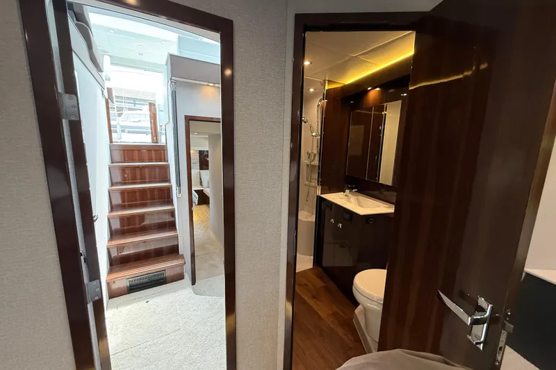  Yacht Photos Pics Interior of 2022 Cruisers Yachts 50 Cantius, featuring stairs and a modern bathroom.