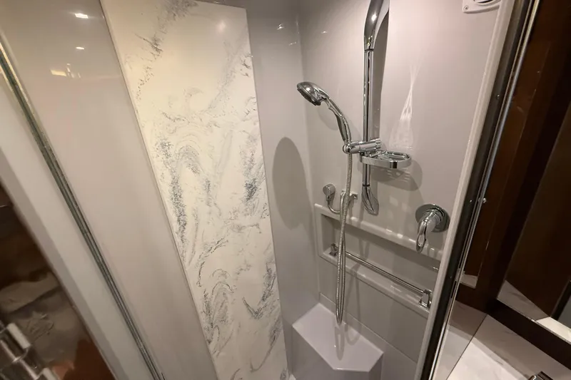  Yacht Photos Pics Luxurious shower in 2022 Cruisers Yachts 50 Cantius with modern fixtures and marble accents.