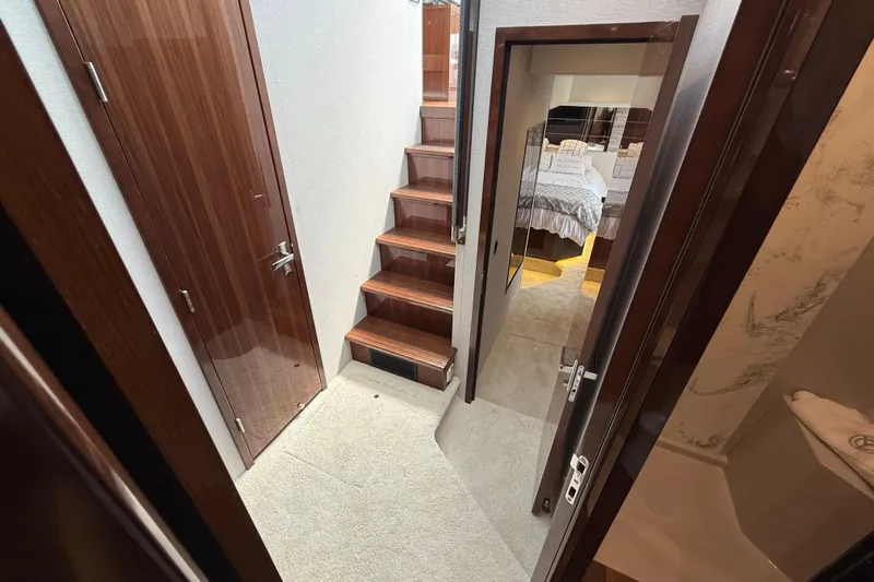  Yacht Photos Pics Interior of 2022 Cruisers Yachts 50 Cantius, featuring stairs and a cozy bedroom.