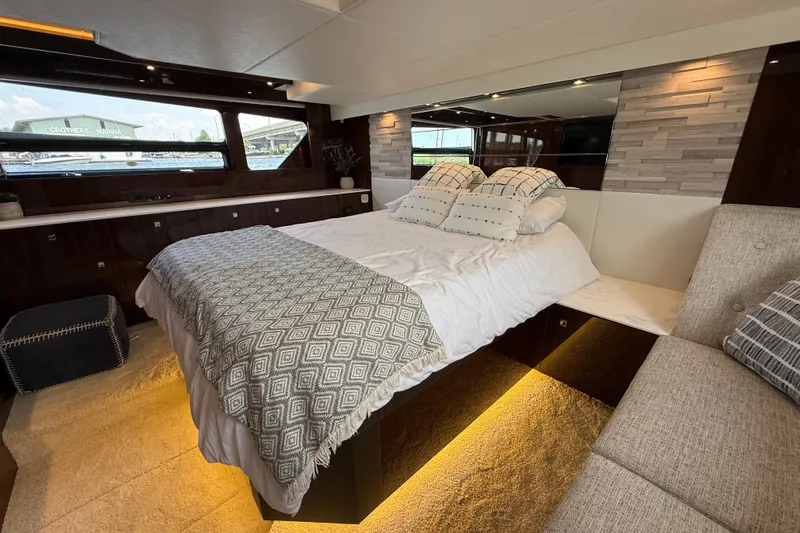  Yacht Photos Pics Luxurious bedroom interior of 2022 Cruisers Yachts 50 Cantius with modern decor and ambient lighting.