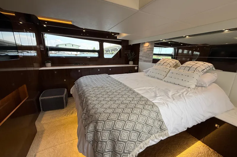  Yacht Photos Pics Luxurious bedroom interior of 2022 Cruisers Yachts 50 Cantius with elegant bedding and modern design.
