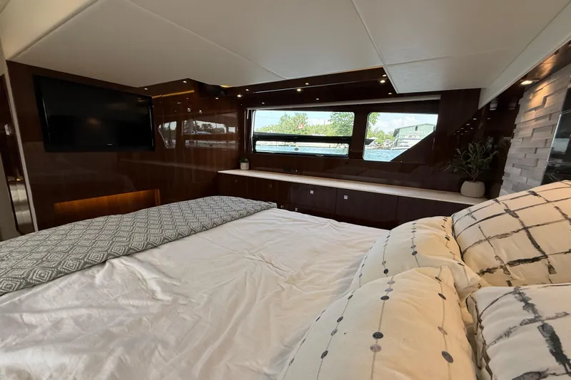  Yacht Photos Pics Luxurious 2022 Cruisers Yachts 50 Cantius bedroom with elegant decor and large windows.