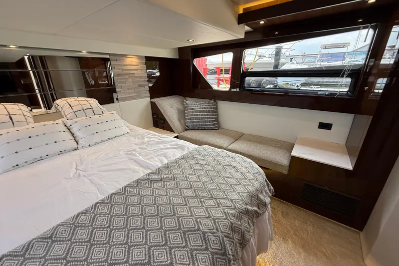  Yacht Photos Pics Luxurious bedroom interior of 2022 Cruisers Yachts 50 Cantius with elegant bedding and window view.