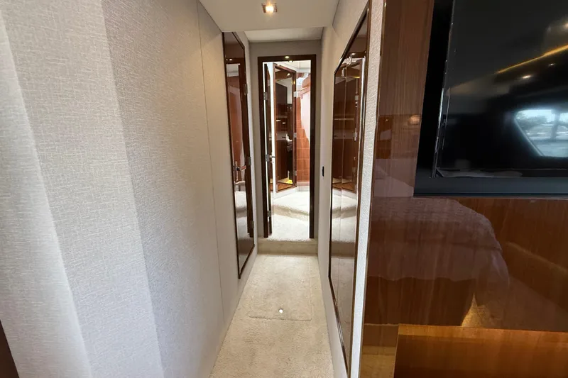  Yacht Photos Pics Luxurious interior hallway of 2022 Cruisers Yachts 50 Cantius, featuring elegant wood finishes.