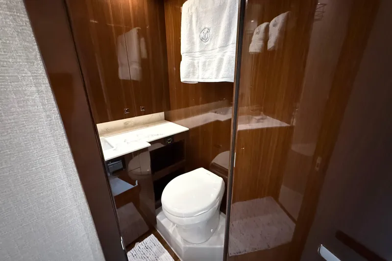  Yacht Photos Pics Luxurious bathroom in 2022 Cruisers Yachts 50 Cantius with modern amenities and elegant wood finish.