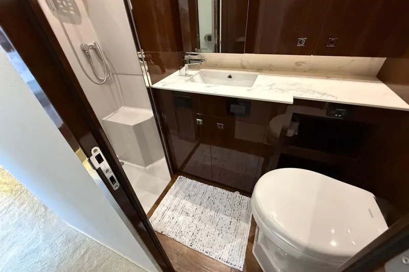  Yacht Photos Pics Luxurious bathroom in 2022 Cruisers Yachts 50 Cantius with modern fixtures and elegant design.